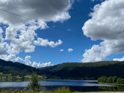 a view of a lake with mountains in the background at Voss- Oppheim suite private cozy cabin in Vossestrand