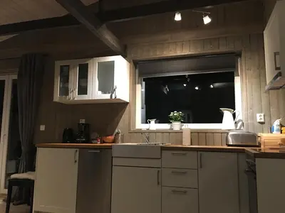 a kitchen with a sink and a window at Voss- Oppheim suite private cozy cabin in Vossestrand