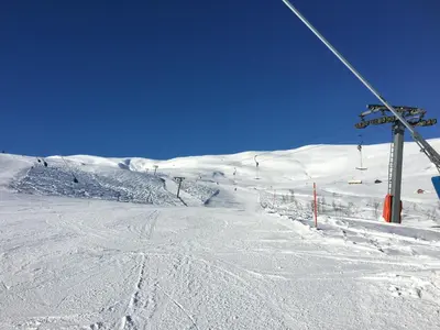 a snow covered ski slope with a ski lift at Voss- Oppheim suite private cozy cabin in Vossestrand