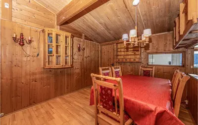 a dining room with a table and chairs in a cabin at Awesome Home In Vatne With Wifi in Vatne
