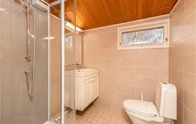 a bathroom with a toilet and a glass shower at Awesome Home In Vatne With Wifi in Vatne