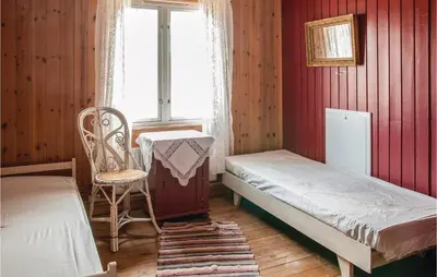 a bedroom with a bed and a table and a chair at Beautiful Home In Tynset With Kitchen in Tynset
