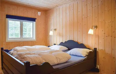 a bed in a room with wooden walls and a window at Nice Home In Gol With Kitchen in Gol