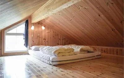 a bed in a room with a wooden ceiling at Stunning Home In Hemsedal With Kitchen in Hemsedal