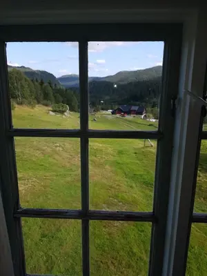 a window view of a field from a house at Kvambekk Gard i Åmotsdal in Åmotsdal