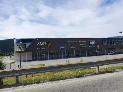 a large building with a sign on the side of it at Bårdshaug Studio Apartment in Orkanger