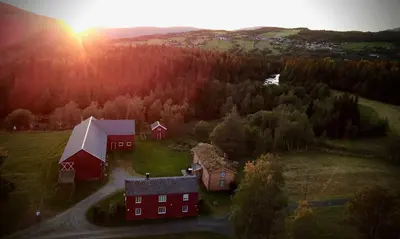 an aerial view of a farm with a red barn at Kirkvollen pilegrimsgård in Tydal