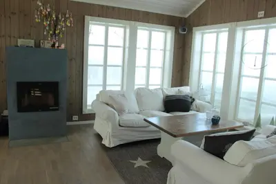 a living room with white furniture and a fireplace at Torshaug 4 bedroom cabin in Gol