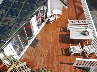 an overhead view of a deck with chairs and tables at Seaside Fisherman s Haven-By Traum in Steinsbø