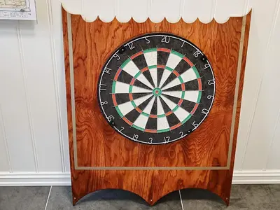 a dart board on a wooden wall at Seaside Fisherman s Haven-By Traum in Steinsbø