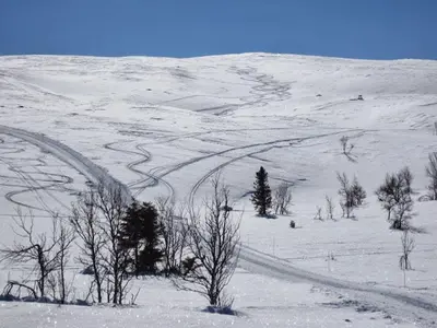 a snow covered hill with trees and a road at Luxembu - 4 bedroom cabin with a fantastic view in Gol