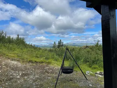 a basket hanging from a pole in a field at Linnaeus - 6 person cabin in Ål