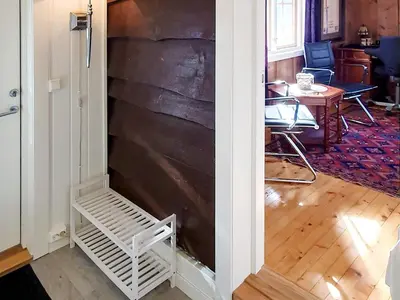 a door leading into a room with a wood wall at Cozy Cottage Retreat in Trend-By Traum in Frei