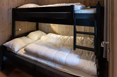a black bunk bed with white pillows on it at Trysiltunet 16b in Trysil