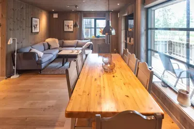 a living room with a wooden table and a couch at Trysiltunet 16b in Trysil