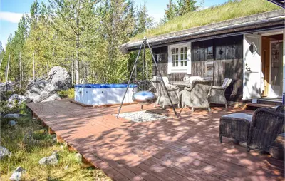 a patio with a swing and a house at Cozy Home In Hemsedal With Kitchen in Hemsedal