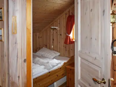 a small room with a bed in a wooden cabin at 6 person holiday home in Brekstad in Brekstad