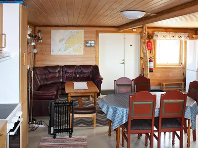 a living room with a couch and a table and chairs at 6 person holiday home in Brekstad in Brekstad