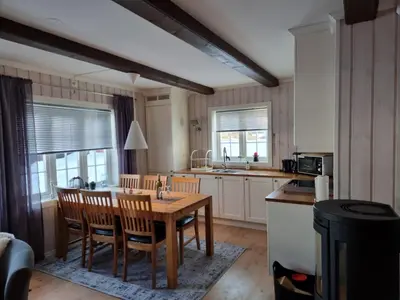 a kitchen with a table and chairs and a kitchen with a sink at Gaustatoppen Apartment in Rjukan