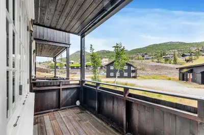 an outdoor balcony with a view of the mountains at Gaustatoppen Apartment in Rjukan