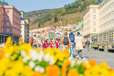 a group of people walking down a city street at Hotel No13 in Bergen