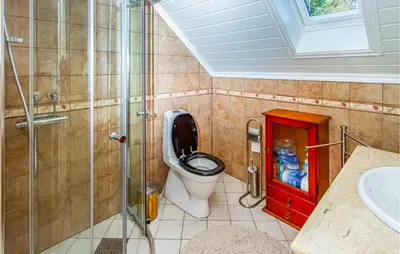 a bathroom with a toilet and a glass shower at 2 Bedroom Amazing Apartment In Vestnes in Vestnes