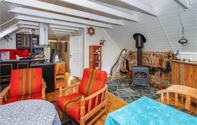 a kitchen with a table and chairs and a stove at 2 Bedroom Amazing Apartment In Vestnes in Vestnes