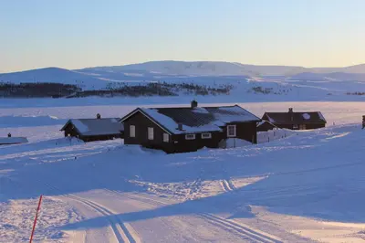 a group of houses in a snow covered field at Kjøniksbu - 3 bedroom cabin in Ål