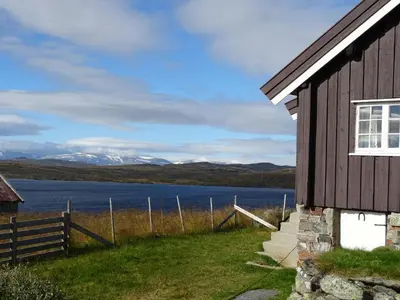 a house with a view of a lake and mountains at Veslehytta - cabin 1050 moh via amazing view and ambiance in Ål