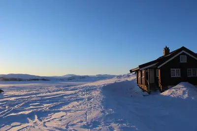 a house in the middle of a snow covered field at Veslehytta - cabin 1050 moh via amazing view and ambiance in Ål