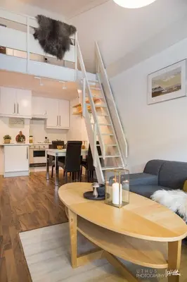 a living room with a table and a staircase at Actif 305 Apartment by Ål Ski Center in Ål