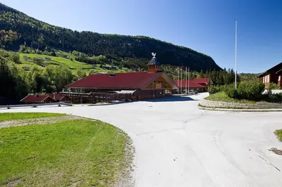 a large building with a church in front of a mountain at Actif 305 Apartment by Ål Ski Center in Ål