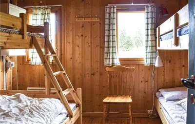 a bedroom with two bunk beds and a window at Stunning Home In Sjusjøen With Kitchen in Sjusjøen