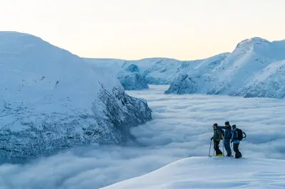 a group of three people standing on top of a glacier at Hotel Alexandra Loen in Loen