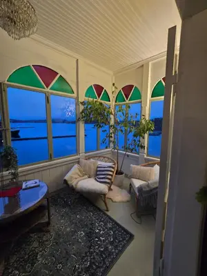 a living room with stained glass windows at Skjerjehamn in Ånneland