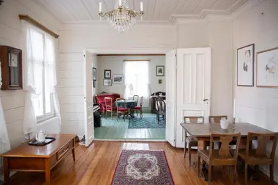 a dining room with a table and chairs in it at Skjerjehamn in Ånneland