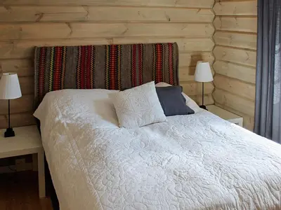 a bedroom with a white bed with two lamps at 6 person holiday home in Svingvoll in Svingvoll