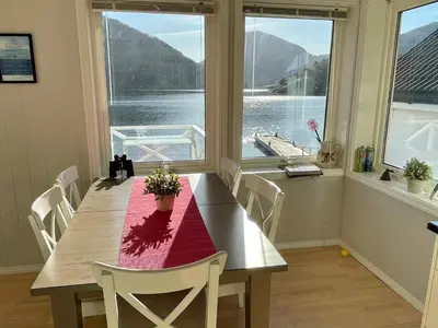 a dining room with a table and a large window at 6 person holiday home in ETNE in Etnesjøen
