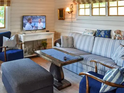 a living room with a couch and a tv at Family Oasis with Lake View-By Traum in Ålesund