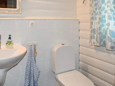 a bathroom with a toilet and a sink at Family Oasis with Lake View-By Traum in Ålesund