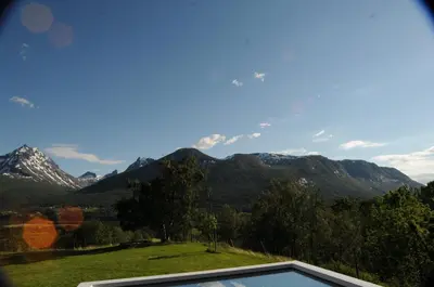 a view of a mountain range from a house at Romsdalseggen Lodge in Isfjorden