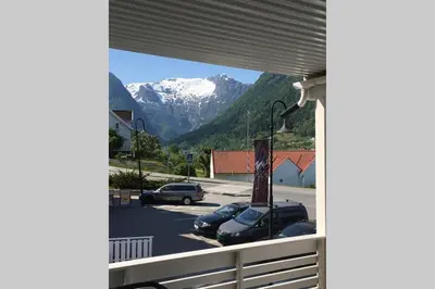a view of a snow covered mountain from a balcony at Balestrand Fjordapartments Holmen 19A in Balestrand