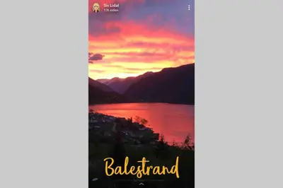 a sunset over a lake with the words bled island at Balestrand Fjordapartments Holmen 19A in Balestrand