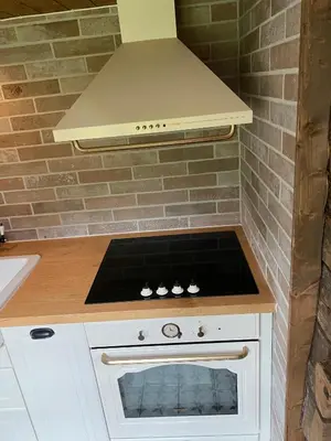 a kitchen with a stove top oven in a kitchen at Eidegrend Boutique Hotel in Eikelandsosen