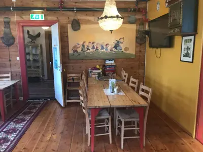 a dining room with a wooden table and chairs at Eidfjord Hytter in Eidfjord