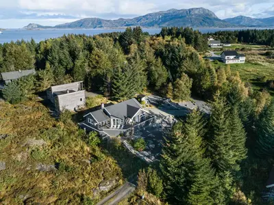 an aerial view of a house on a hill with trees at Holiday Home Sjøbuvågen by Interhome in Korssund
