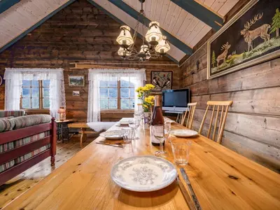 a dining room with a wooden table in a cabin at Chalet Eiketun by Interhome in Olden