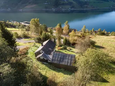 an old house on the shore of a lake at Chalet Eiketun by Interhome in Olden
