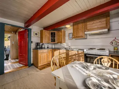 a kitchen with a table and a red door at Chalet Eiketun by Interhome in Olden