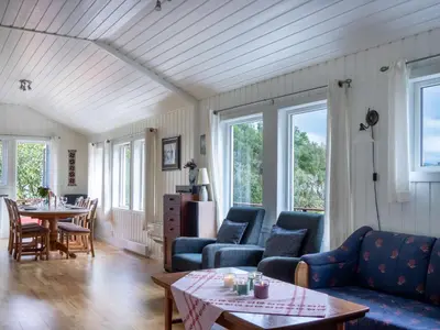 a living room with blue couches and a table at Holiday Home Fjordglytt by Interhome in Onarheim